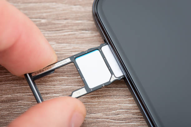 istock Inserting tray with sim cards to the phone 1457327968