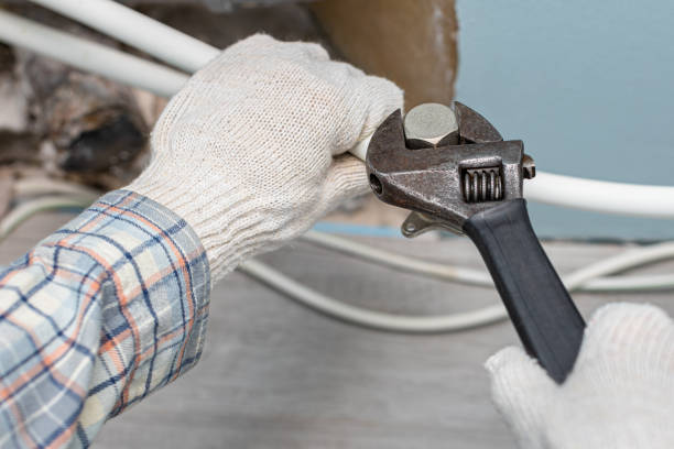 istock man repairing a pipe with a pipe wrench 1457329978
