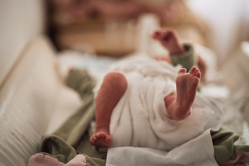 Newborn baby's feet on the changing table.