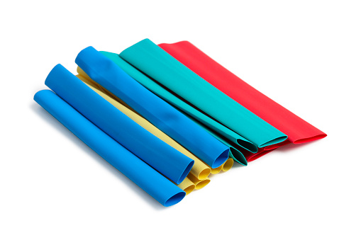 Multi-colored tubes made of soft heat-shrinkable plastic for insulating electrical connections