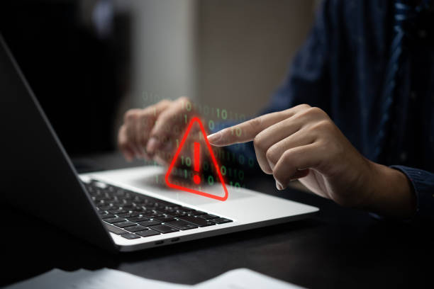 Businessman programmer, developer using laptop computer with triangle caution warning sign for notification error and maintenance concept. Businessman programmer, developer using laptop computer with triangle caution warning sign for notification error and maintenance concept. oops stock pictures, royalty-free photos & images