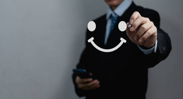 istock Businessman drawing a happy face smile face. Customer service experience, satisfaction survey, feedback and review concepts. 1457332132