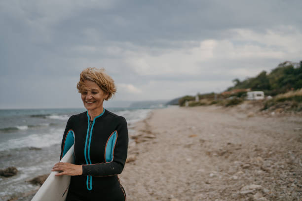 istock Woman surfer on the beach 1457332294