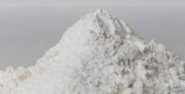 istock Close up Pile of Tapioca starch explosion flying, White powder tapioca starch wave floating fall down in air. tapioca starch is element material. Eyeshadow crush for make up artist. White background 1457335041