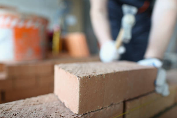 istock Closeup of industrial bricklayer laying bricks at construction site 1457335286