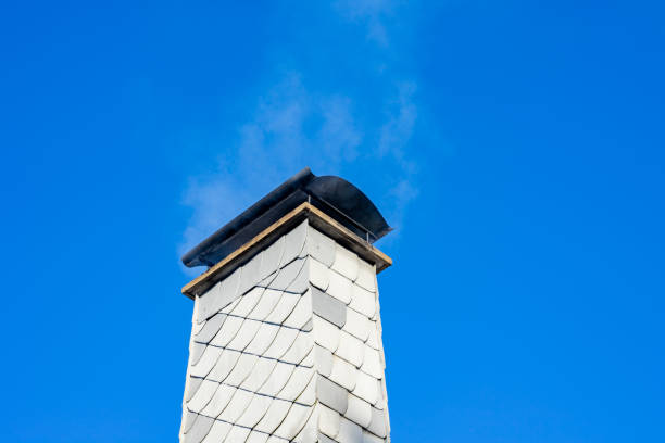 istock smoke from a chimney of a house 1457337534