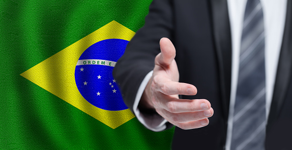 Welcome to the Brazil. Hand on Brazilian flag background. Business, politics, cooperation and travel concept