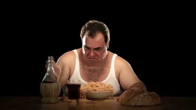 hungry-fat-man-eats-a-big-plate-of-spaghetti.jpg