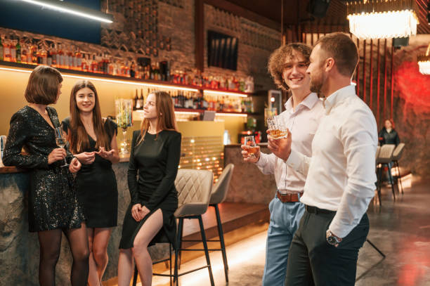 istock Two men are standing at the party together with alcohol drinks in hands 1457342791
