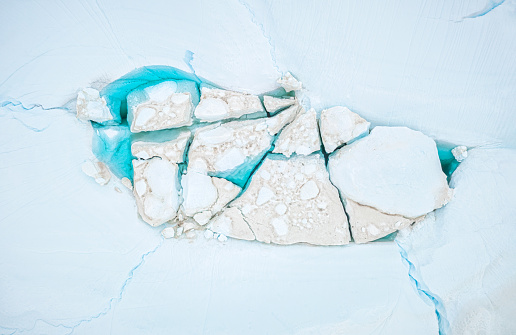 top view of icebergs melting in a blue lagoon in the arctic. Greenland