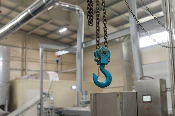 istock Large lifting hook on dirty chain against background of a blurred industrial workshop 1457343906