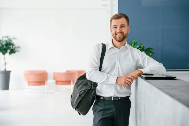 istock Standing at reception. Elegant man in formal clothes is indoors 1457344590