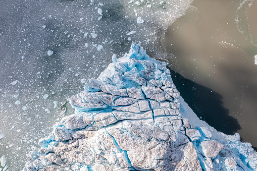 Top view of blue ice melting in Eqi Glacier. Greenland. Climate change warning
