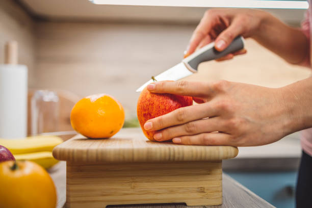 istock Young woman making fruits smoothies with blender 1457344783