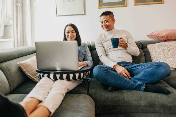 istock Couple at home looking at lapotop in sofa bed 1457344859