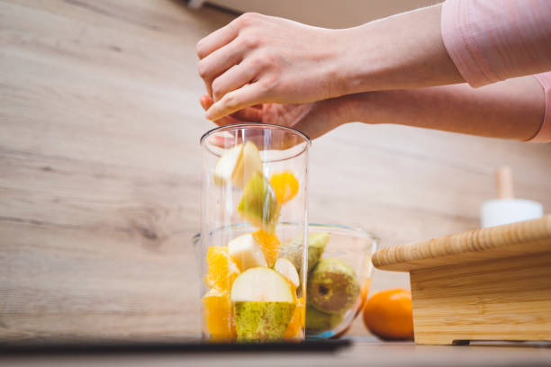 istock Young woman making fruits smoothies with blender 1457344891