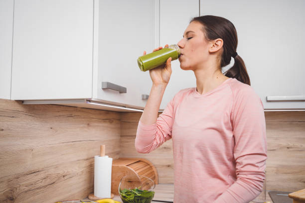 istock Young woman making fruits smoothies with blender 1457344941