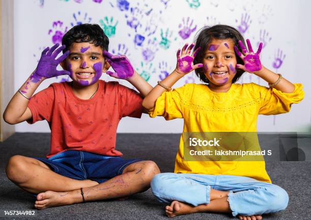 Cheerful Kids With Messy Colorful Hands Grimacing To Camera At Home Concept Of Mischievous Innocent And Humor Stock Photo - Download Image Now