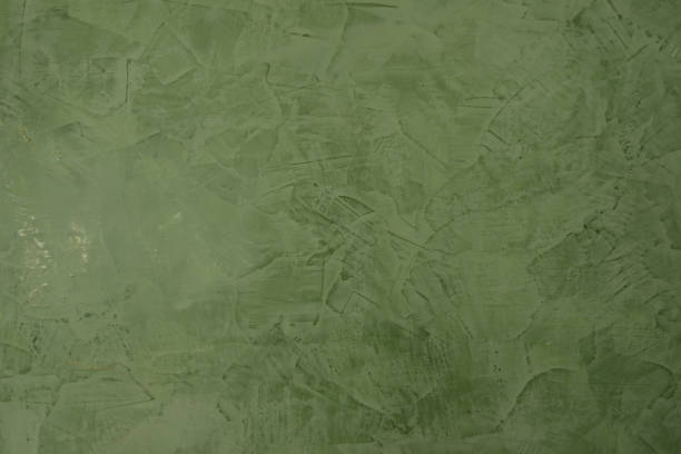 Dark green venetian plaster. Venetian stucco texture. Plastering wall. Decorative plaster background