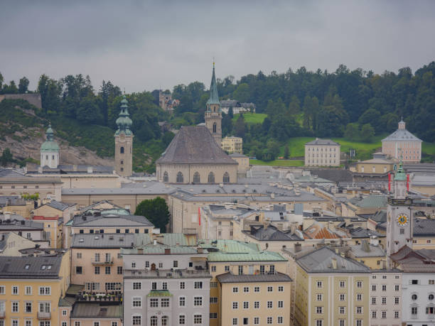 Salzburg Austria inner city with churches. Beautiful view of Salzburg skyline in cloudy summer, Salzburg, Salzburger Land, Austria. The Kollegienkirche and University of Salzburg and other famous places