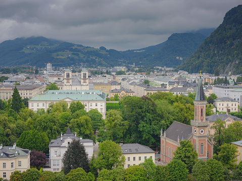 Salzburg is an Austrian city that is divided by the Salzach River and borders Germany. The photograph that you see in front of you shows the Salzach River and the daily life that surrounds it. This summer scene was captured during August of 2008.