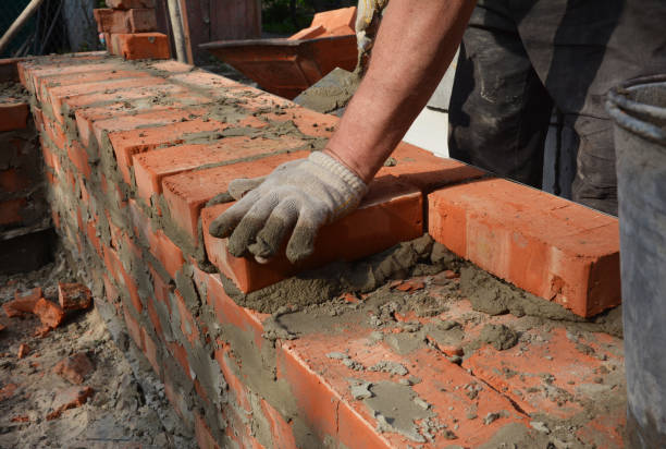 istock Industrial bricklayer photo. Bricklayer bricklaying brick wall. Masonry work close up. 1457348718
