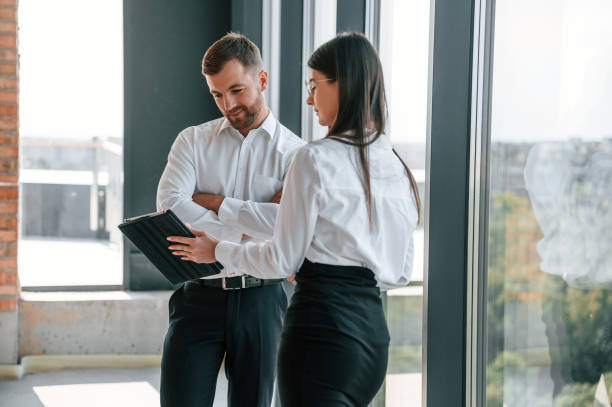 istock Modern windows. Industry workers are in the building at daytime. Construction location 1457348961
