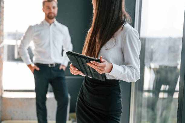 istock Standing with documents in hands. Industry workers are in the building at daytime. Construction location 1457349667