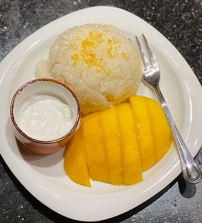Famous dessert from Thailand, mango with glutinous rice and coconut sauce