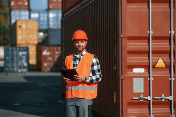 istock With tablet in hands. Male worker is on the location with containers 1457352804