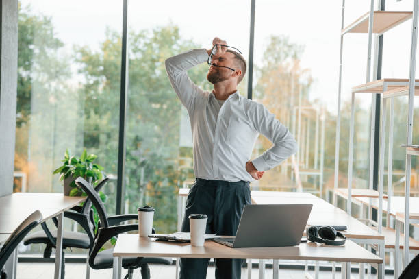 istock Angry, feeling tired and bad. Man in formal clothes is working in the modern office 1457355206