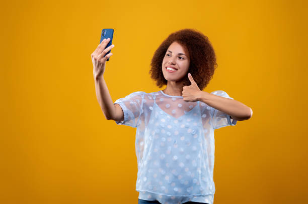 istock Young woman looking contened and making selfie 1457357532