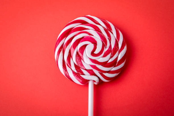 istock Candy on a stick, lollipop. Red background 1457357786