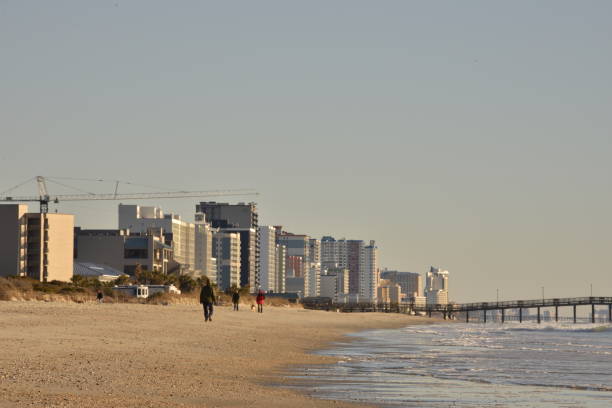 istock People Walking At Myrtle Beach After Sunrise 1457359333