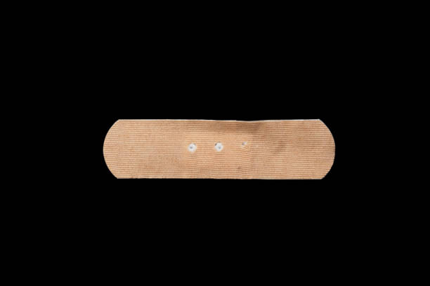 istock Adhesive plaster isolated on black background 1457364398