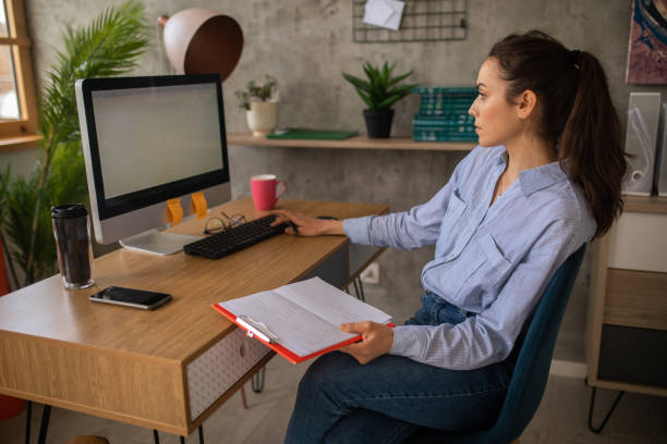 istock Woman working on a desktop PC at home 1457366180