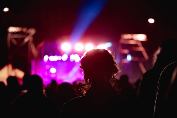 istock Silhouettes of concert crowd with stage lights 1457367274