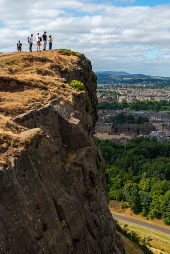 Edinburgh,Scotland-August 01 2022: Visitors climb to Arthur's seat and Crow Hill to admire impressive views across Edinburgh City,on a warm sunny day in the Scottish capital.
