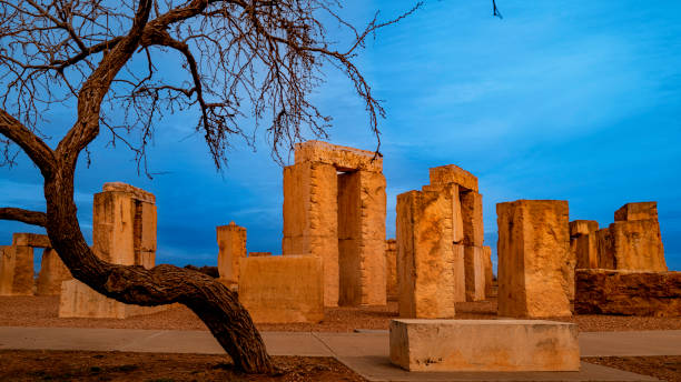 Stonehenge replica of the prehistoric monument and curved bare tree branches