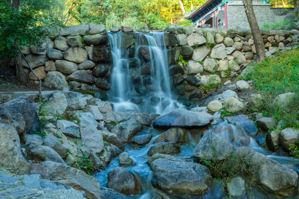 empty stone for product display in nature with waterfall. Free space for product announcements. Selective focus