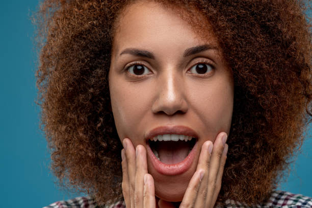 istock Curly-haired young woman looking contented and smiling 1457374912