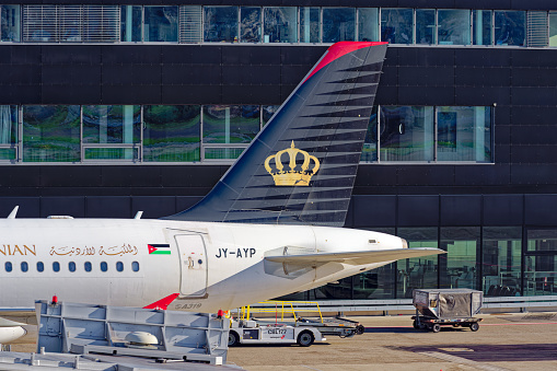 Close-up of tail of stationary airplane of Royal Jordanian Airbus A319-132 register JY-AYP at Zürich Airport on a blue cloudy autumn day. Photo taken November 26th, 2022, Zurich, Switzerland.