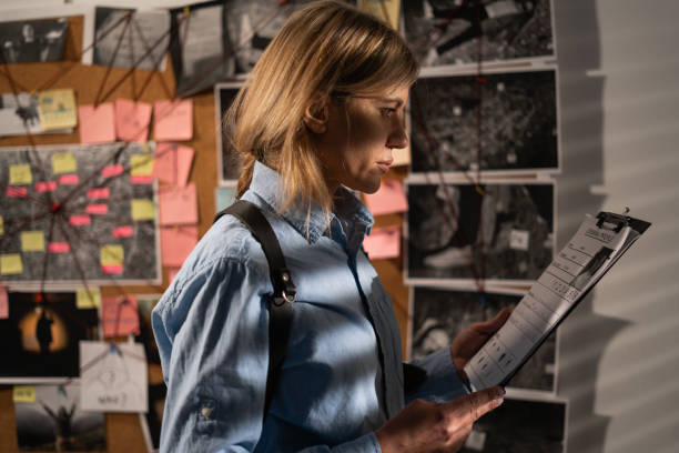 istock Detective looking at evidence board in her office. 1457375422