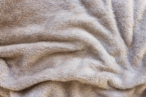 istock Brown fleece throw blanket. Abstract fabric texture background closeup 1457375871