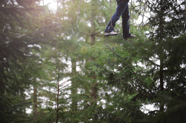 istock Young adult in a large forest obstacle course 1457376978
