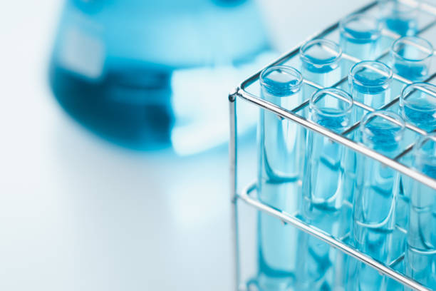 istock Test tubes and erlenmeyer flask filled with blue sample chemicals in chemistry science laboratory. Glassware in medical research. Scientific lab for Biotechnology. 1457377185