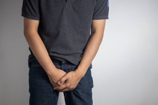 istock Hands covering the crotch of trousers (Gender Disease Concept) 1457377563