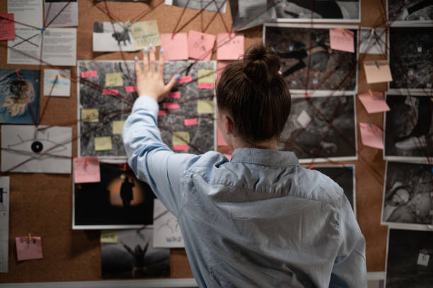 istock Private detective looking attentively at investigation board, back view. 1457378574