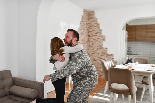 Excited Male Soldier Embracing Small Daughter After Not Seeing Her For A Long Time