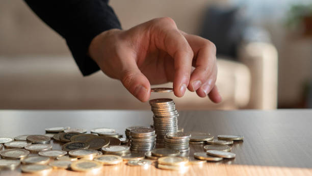 Close-up businessman hand stacks coins Close-up businessman hand stacks coins gold ira companies for young adults stock pictures, royalty-free photos & images